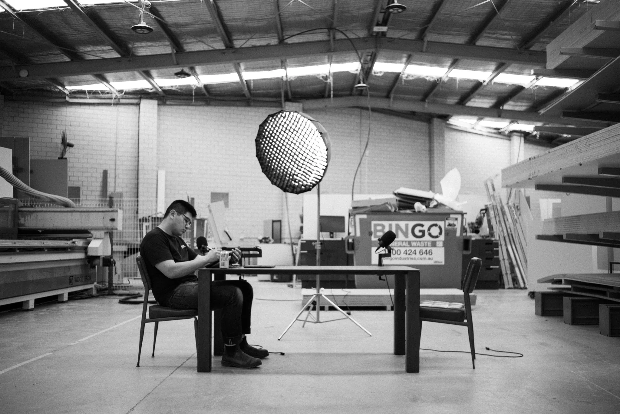 Charley, Plot Joinery's founder, at a table on the workshop floor in Clayton